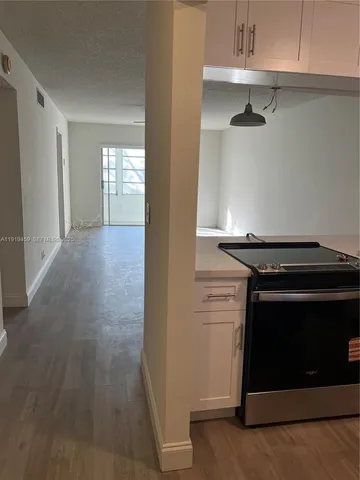a view of a room with wooden floor