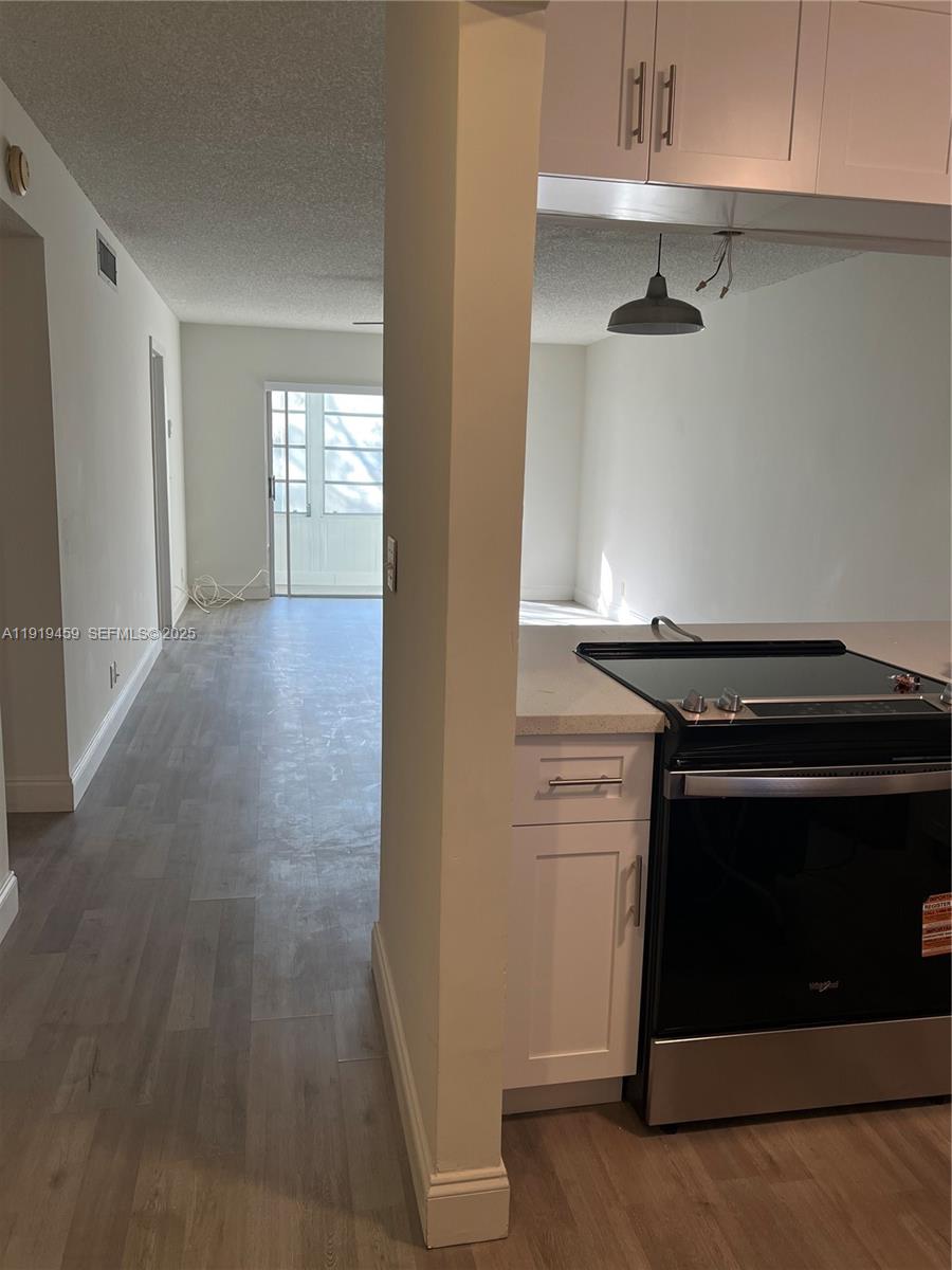 301 Cambridge Road, Unit 211 Hollywood, FL 33024 - Photo 16 of 33 a view of an empty room with a fireplace and a window