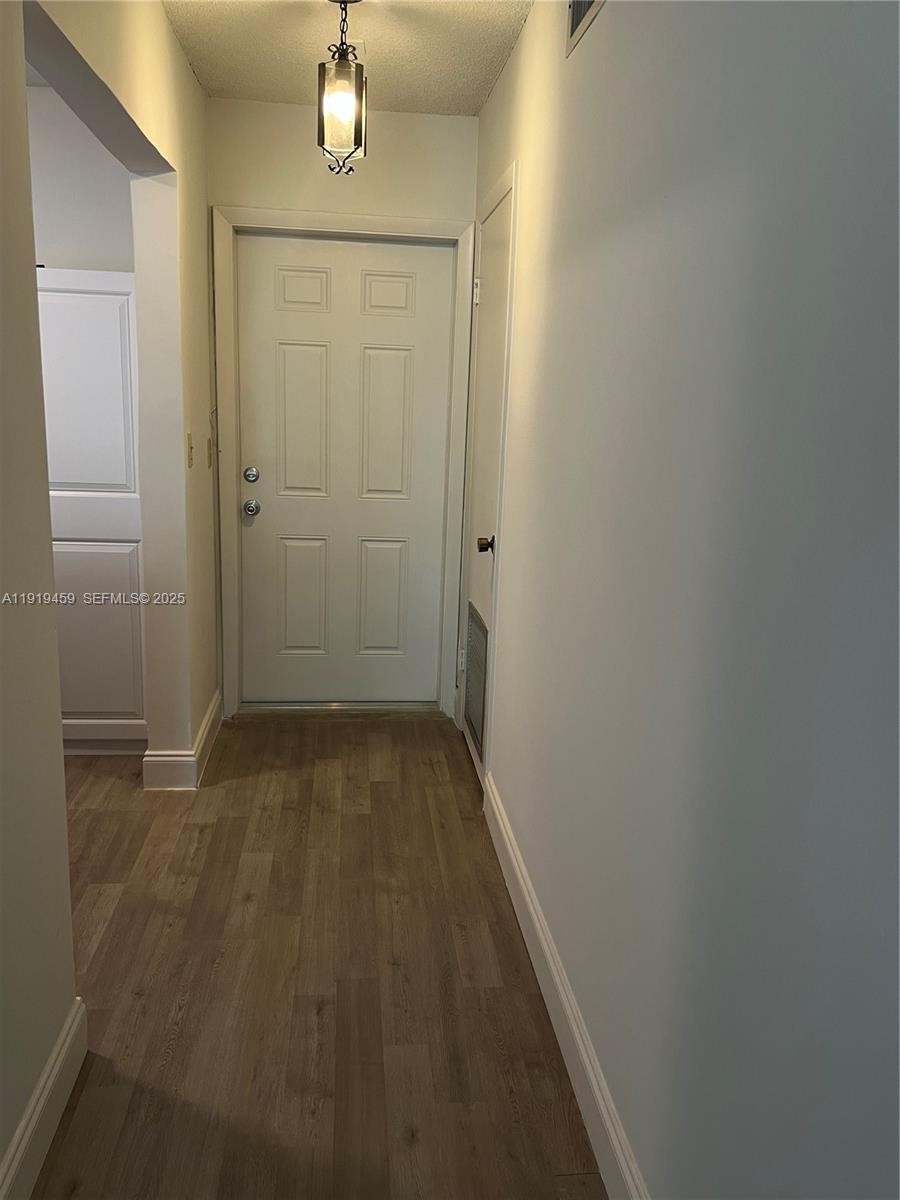 301 Cambridge Road, Unit 211 Hollywood, FL 33024 - Photo 18 of 33 a view of a hallway with wooden floor