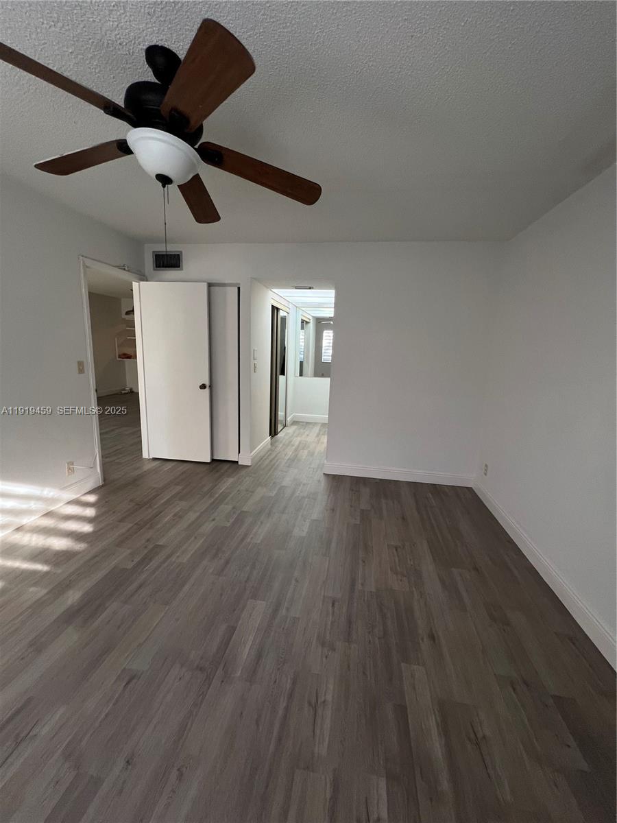 301 Cambridge Road, Unit 211 Hollywood, FL 33024 - Photo 20 of 33 a view of empty room with wooden floor