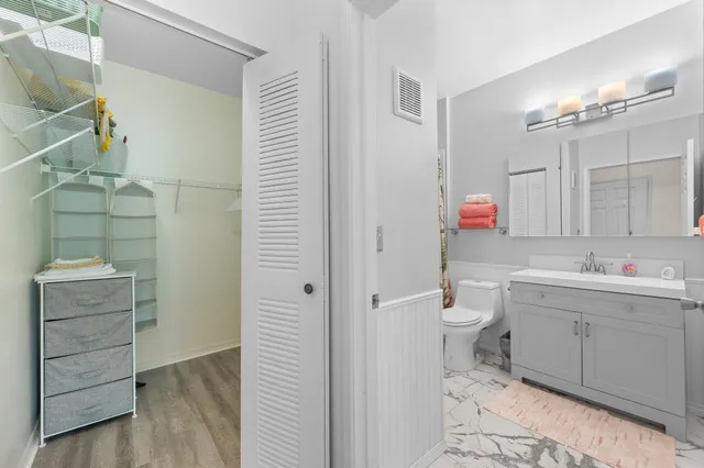 a bathroom with a toilet a sink and shower