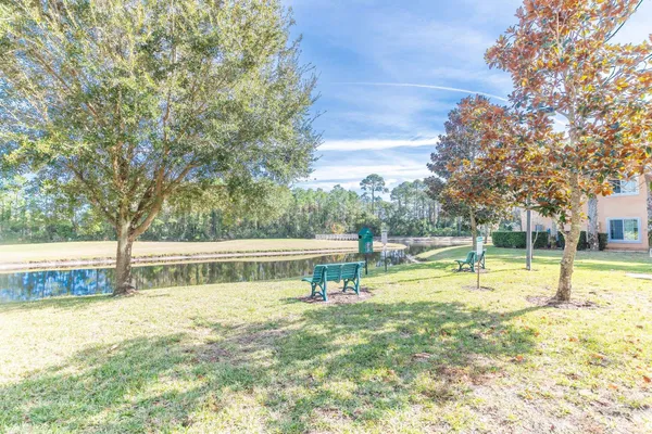a view of swimming pool with trees and sitting space