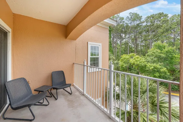 a view of a chair and table in the balcony