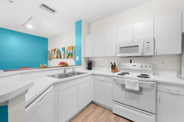 a kitchen with stainless steel appliances granite countertop a sink and cabinets