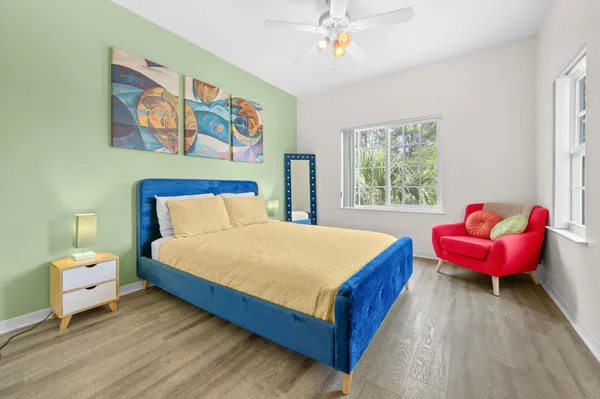 a bedroom with a bed and a painting on the wall