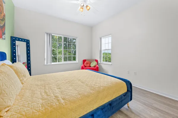 a bed sitting in a bedroom next to a window