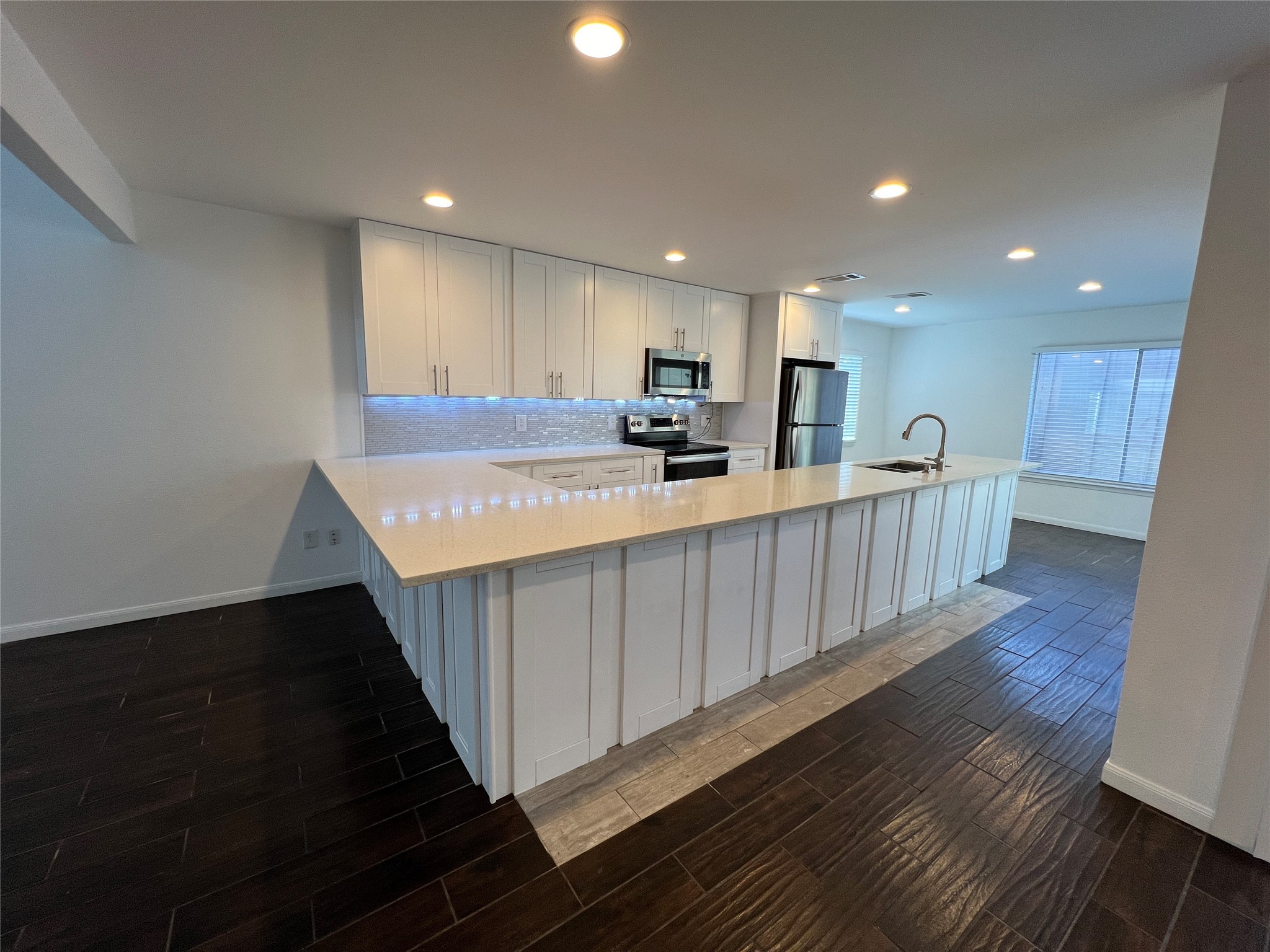 2372 Woodland Park Drive, Unit 121 Houston, TX 77077 - Photo 16 of 47 a kitchen with kitchen island granite countertop wooden cabinets a sink and dishwasher
