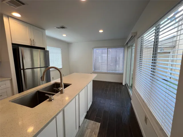 a kitchen with a refrigerator and a sink