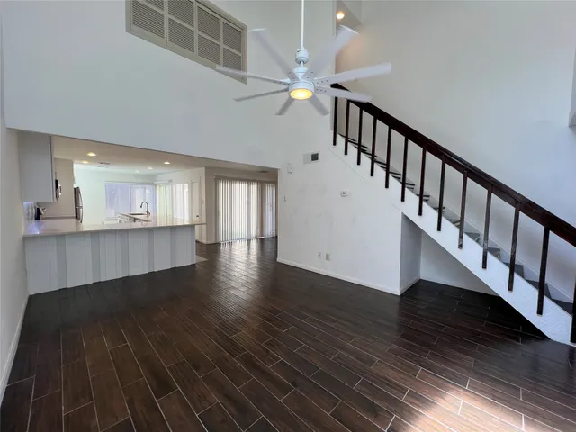 a view of an entryway with wooden floor and staircase
