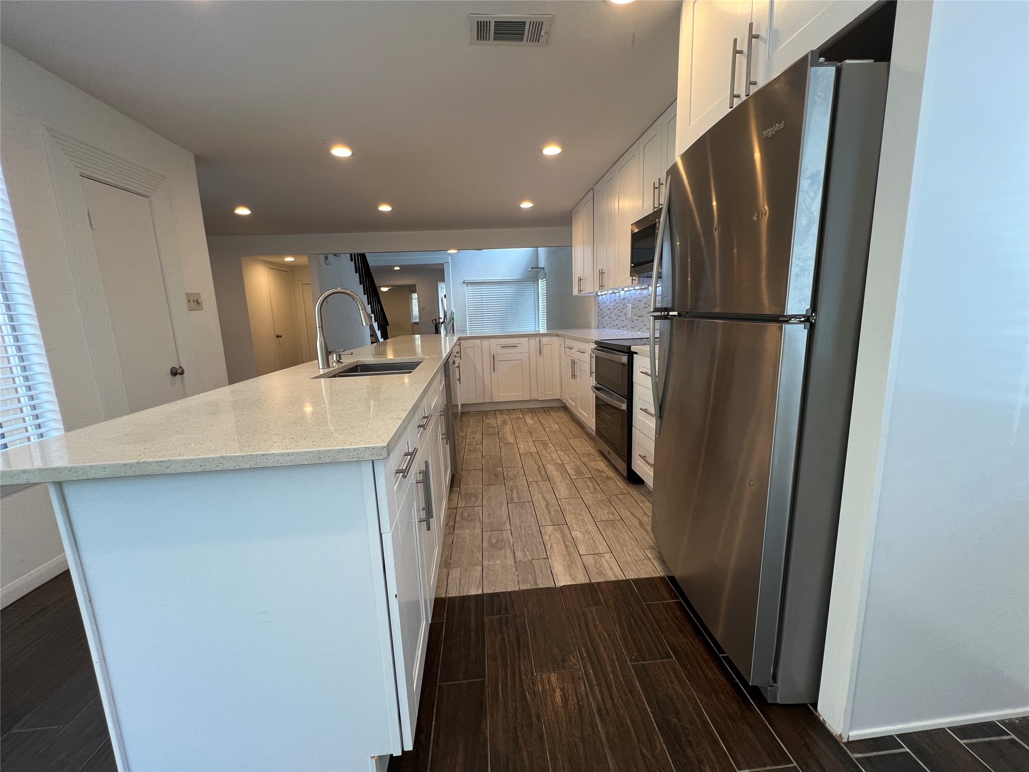 2372 Woodland Park Drive, Unit 121 Houston, TX 77077 - Photo 23 of 47 a kitchen with stainless steel appliances a refrigerator and a sink