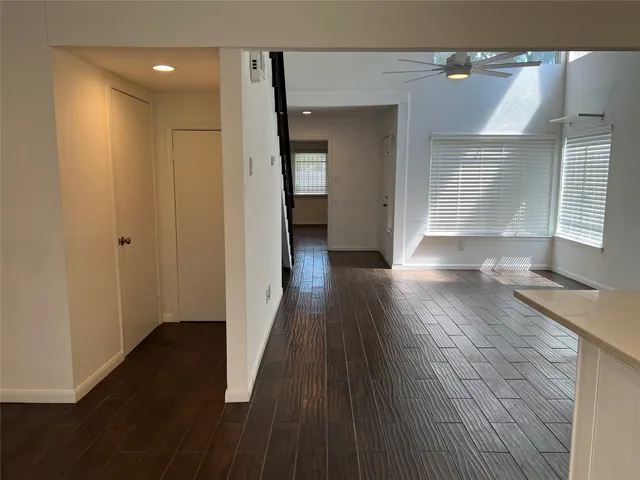 a view of hallway with wooden floor