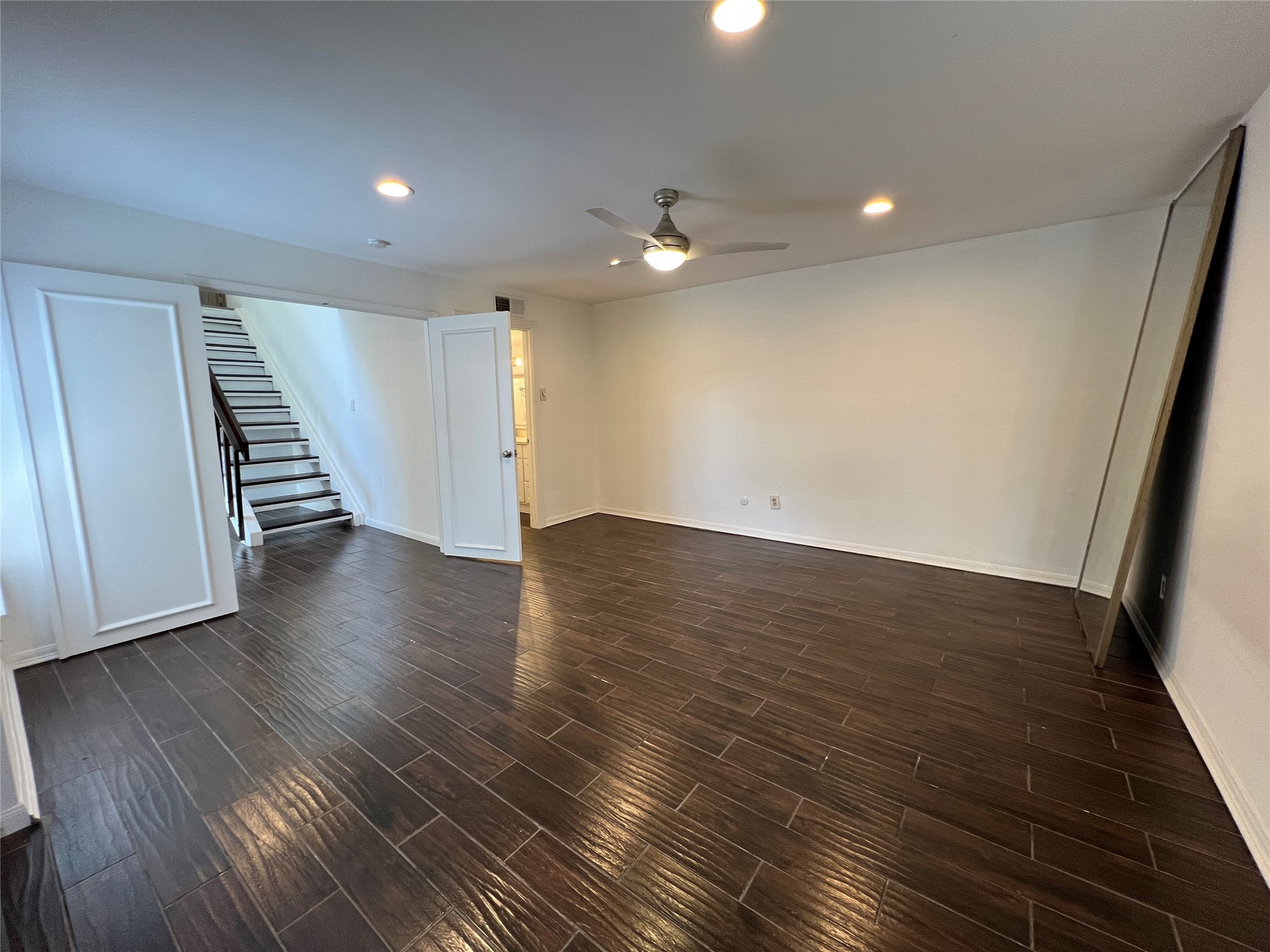 2372 Woodland Park Drive, Unit 121 Houston, TX 77077 - Photo 28 of 47 an empty room with wooden floor and staircase
