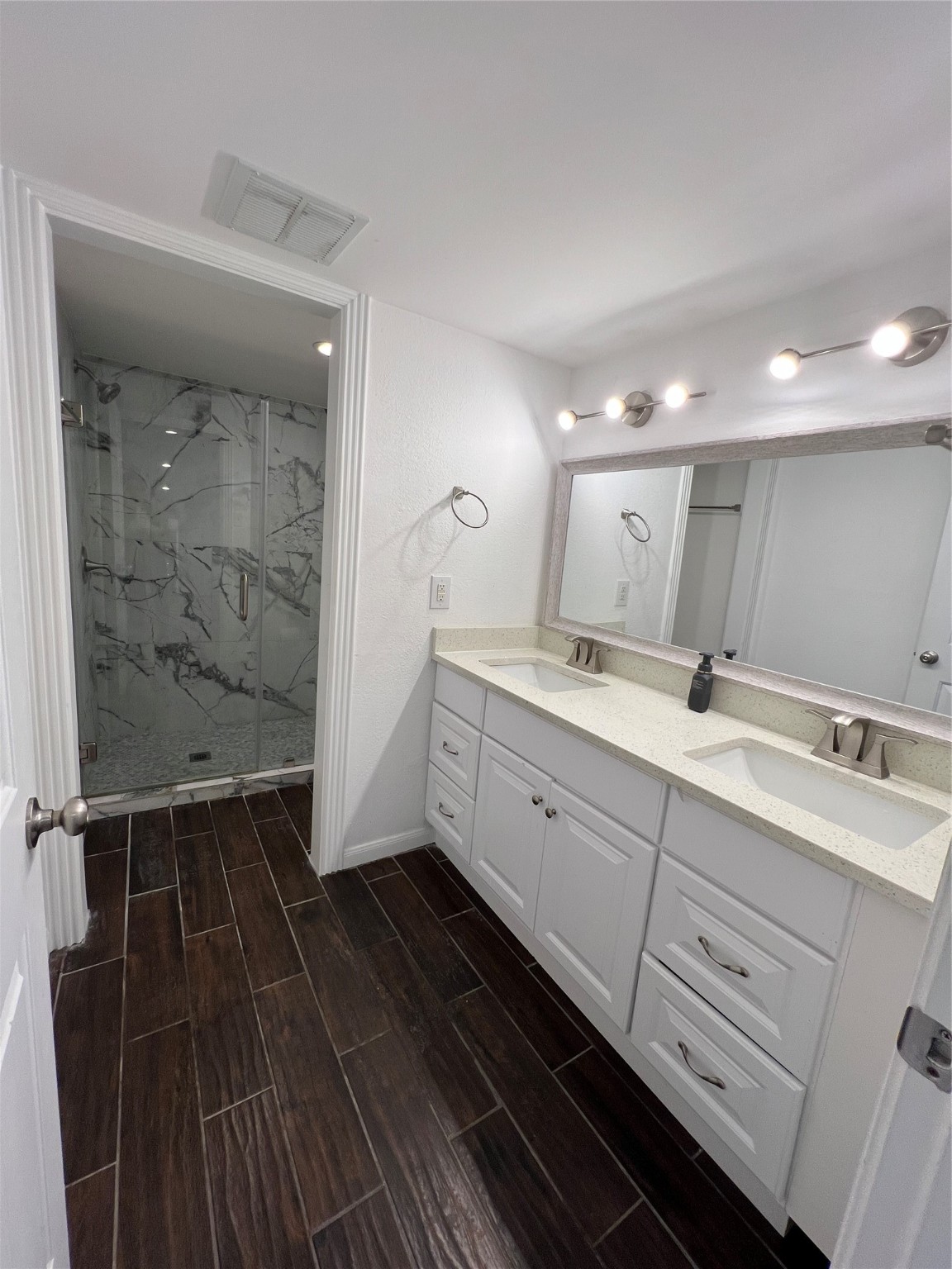 2372 Woodland Park Drive, Unit 121 Houston, TX 77077 - Photo 29 of 47 a bathroom with a double vanity sink and mirror