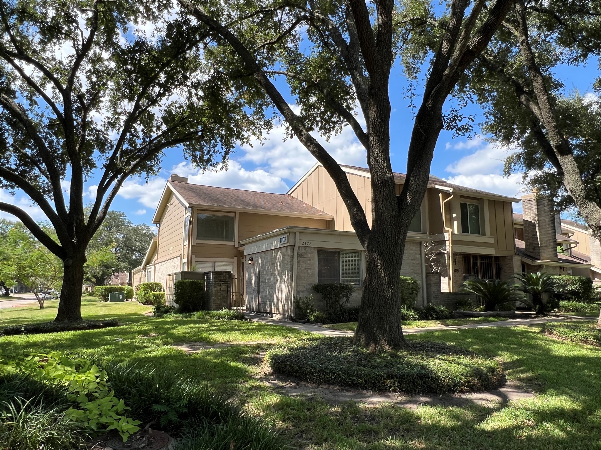 2372 Woodland Park Drive, Unit 121 Houston, TX 77077 - Photo 4 of 47 a front view of a house with a yard