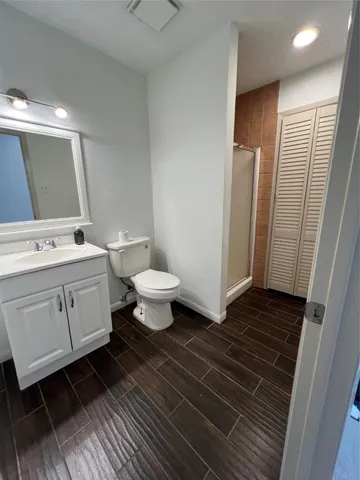 a bathroom with a sink toilet a mirror and vanity