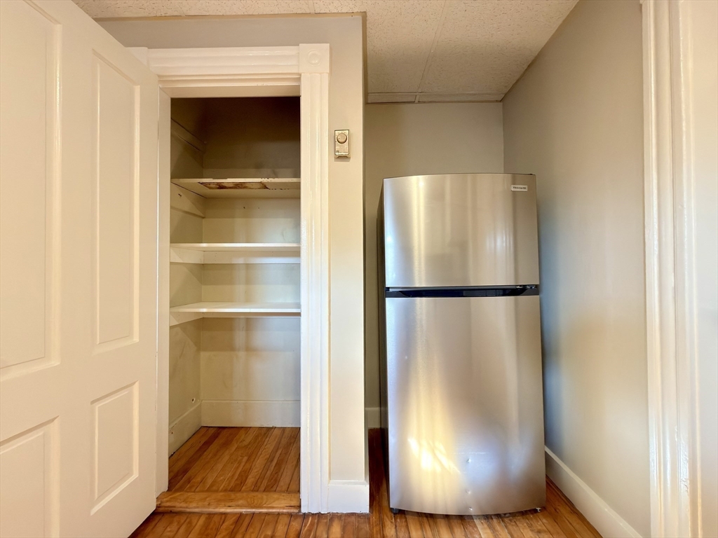 91 Alvarado Avenue, Unit 8 Worcester, MA 01604 - Photo 11 of 26 a view of a room with wooden floor and cabinet