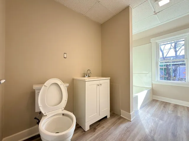 a bathroom with a toilet a sink and a mirror