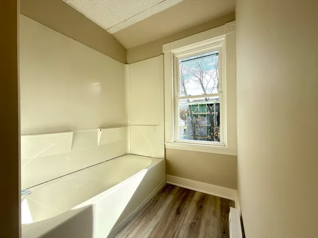 a bathroom with a bathtub and a shower