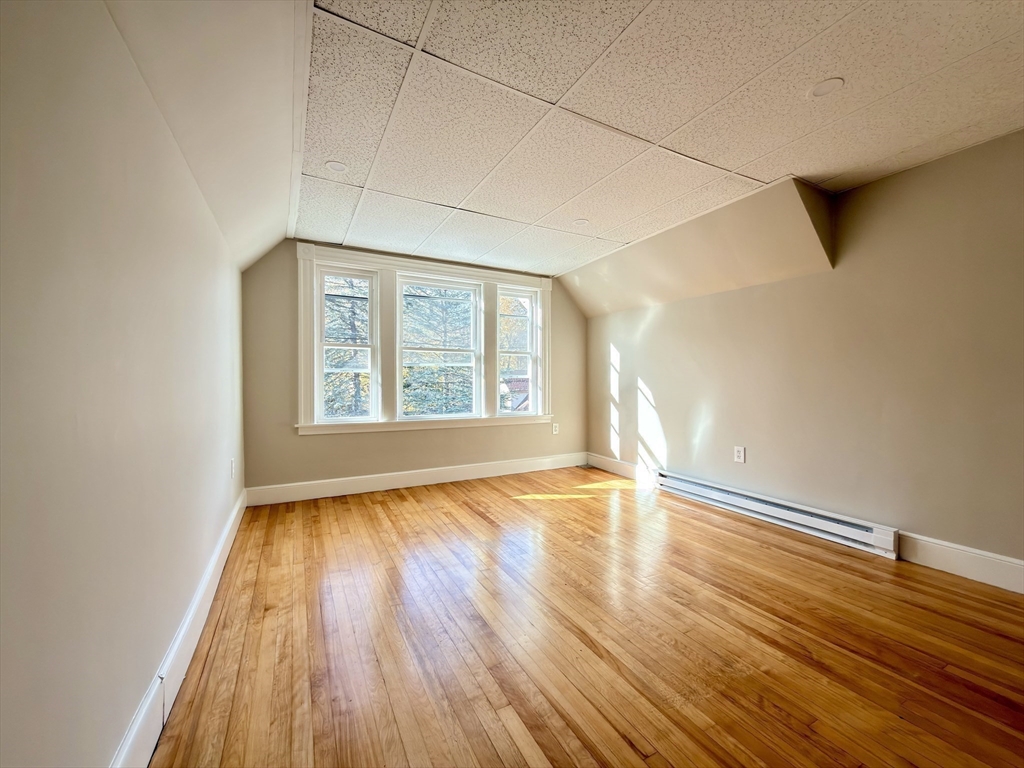 91 Alvarado Avenue, Unit 8 Worcester, MA 01604 - Photo 22 of 26 an empty room with wooden floor and windows