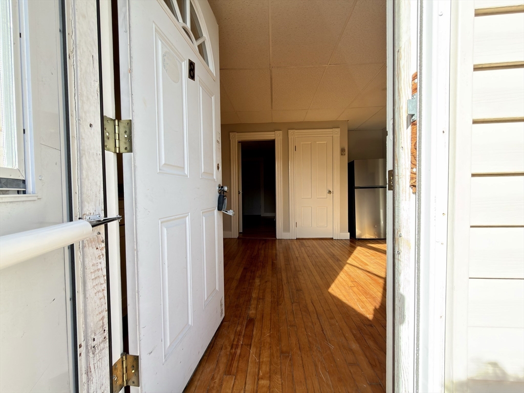 91 Alvarado Avenue, Unit 8 Worcester, MA 01604 - Photo 3 of 26 a view of a hallway with wooden floor and staircase
