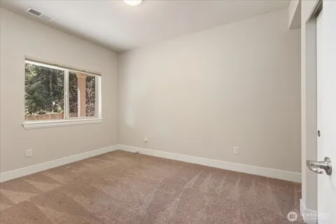 a room with gym equipment and wooden floor