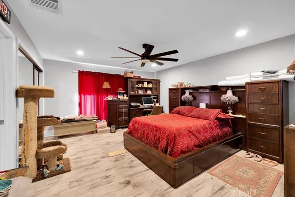 a bed room with a bed and a ceiling fan