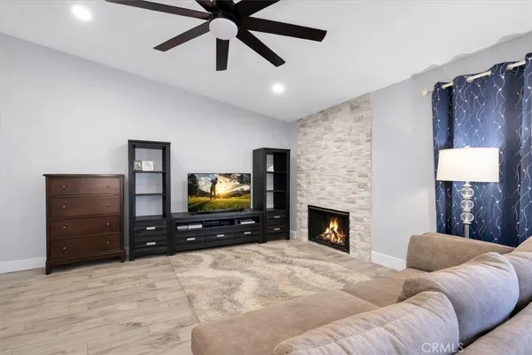 a living room with furniture and a fireplace