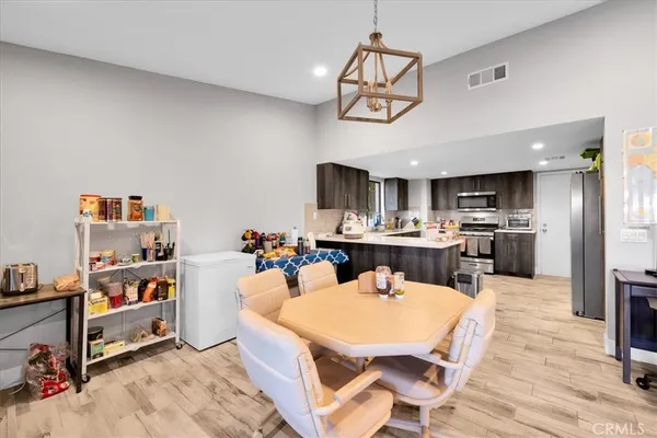 a view of a dining room with furniture and a kitchen