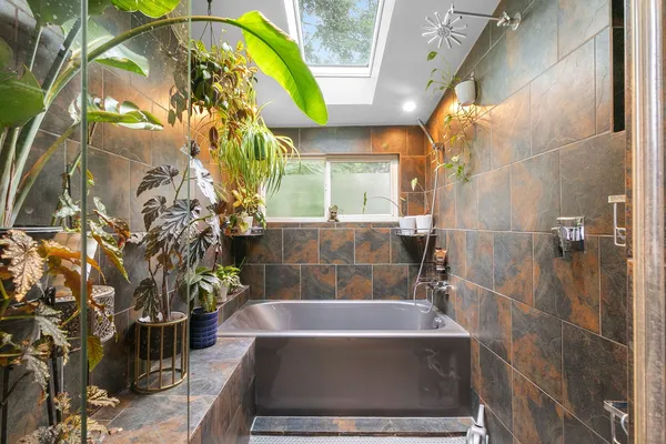 a bathroom with a bathtub and shower