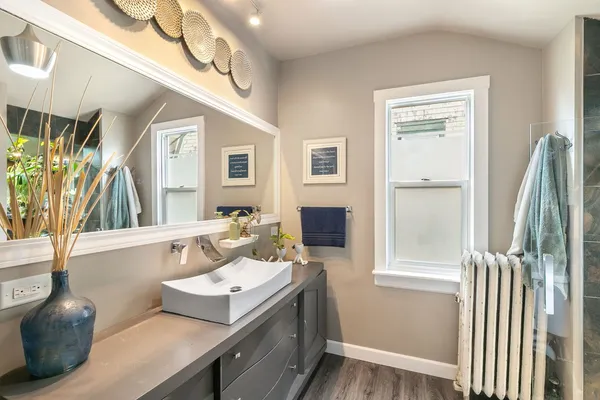 a spacious bathroom with a sink mirror and a bathtub