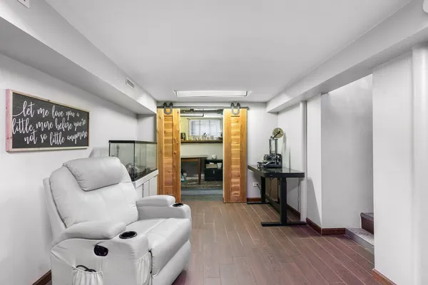 a living room with furniture and wooden floor