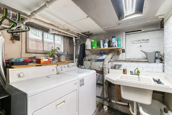 a utility room with sink dryer and washer