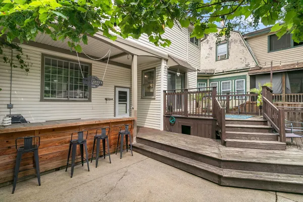 a view of a house with a balcony and furniture