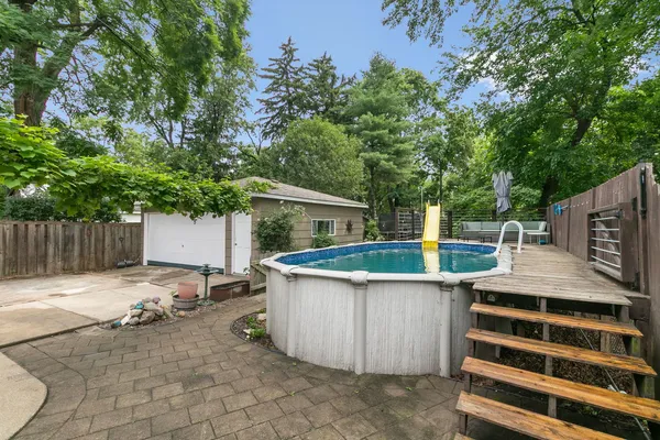 a view of a backyard with wooden fence