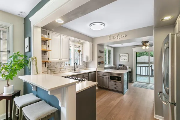 a kitchen with a stove a sink and a refrigerator