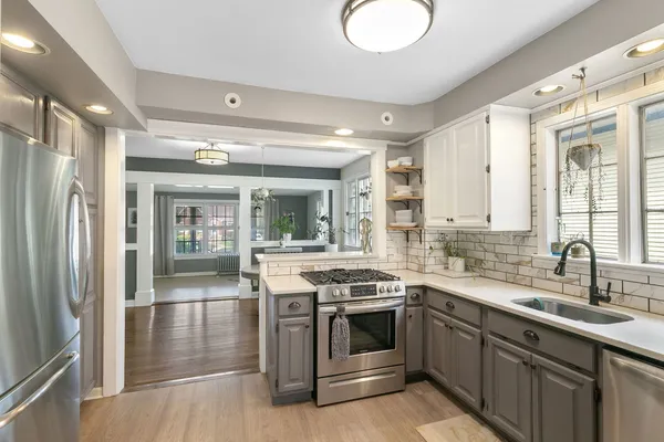 a kitchen with stainless steel appliances granite countertop a stove and a sink