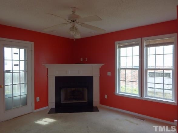 4713 Windbreak Lane Raleigh, NC 27616 - Photo 2 of 6 a living room with a fireplace and a window
