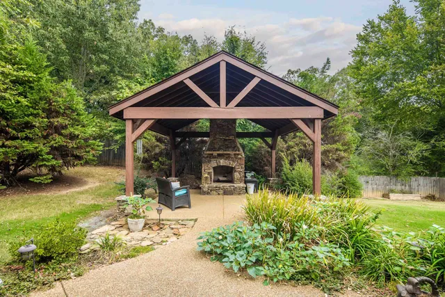 a view of a chair and tables in the backyard of the house