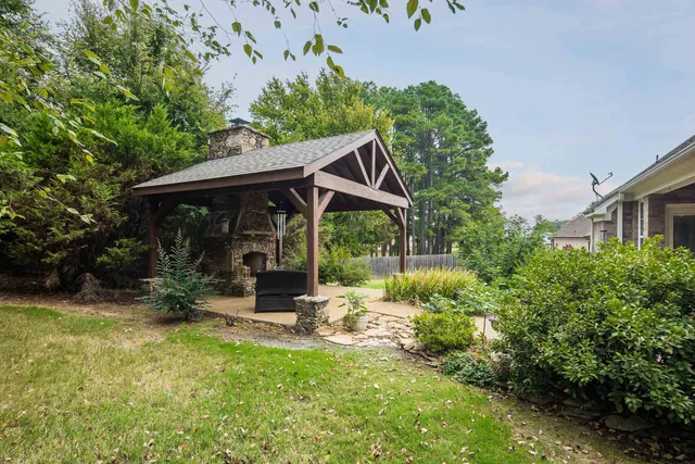 a backyard of a house with yard and outdoor seating