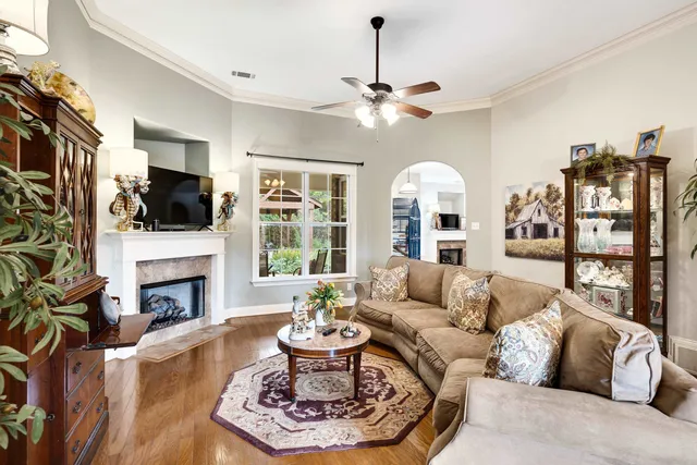 a living room with furniture fireplace and flat screen tv