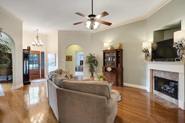 a living room with fireplace furniture and a flat screen tv