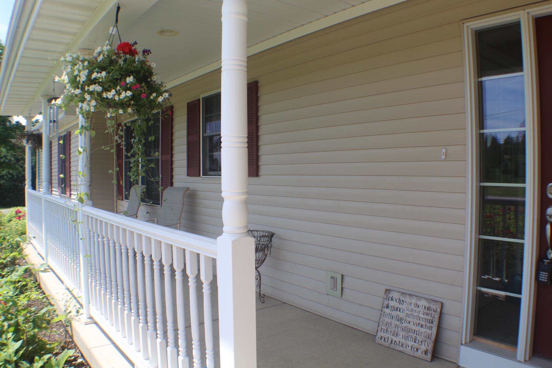 9190 North Barker Road Byron, IL 61010 - Photo 4 of 53 a view of a house with a flower garden