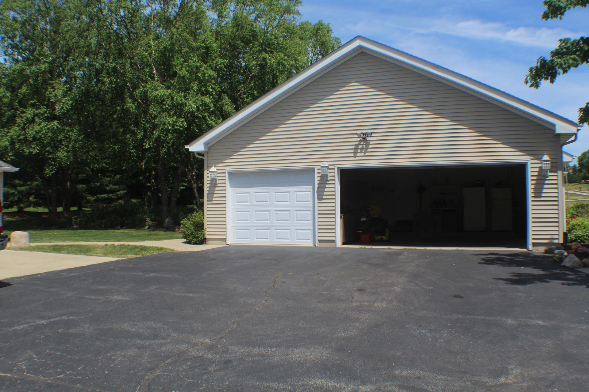 9190 North Barker Road Byron, IL 61010 - Photo 44 of 53 a front view of a house with yard and garage