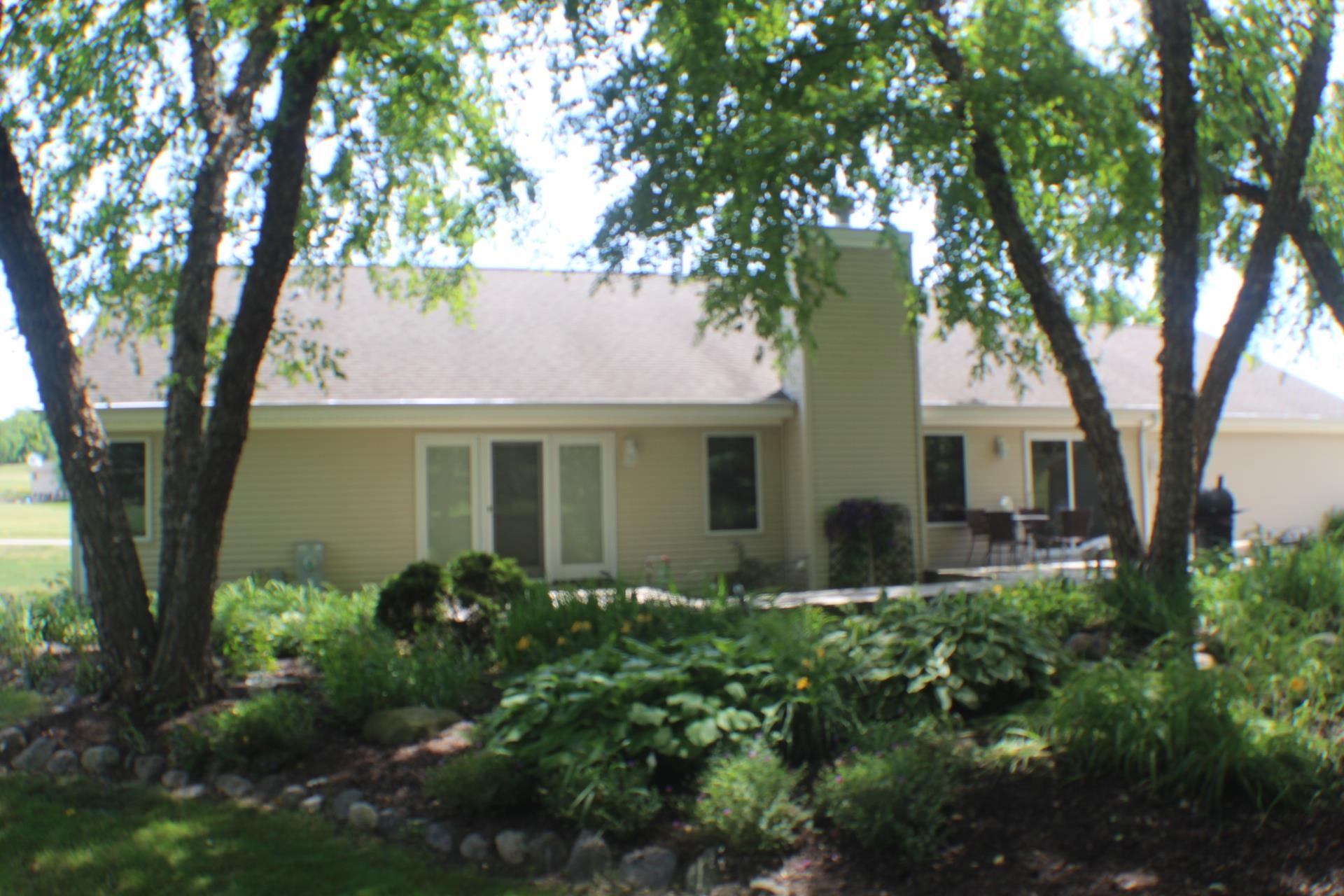 9190 North Barker Road Byron, IL 61010 - Photo 47 of 53 a front view of a house with garden