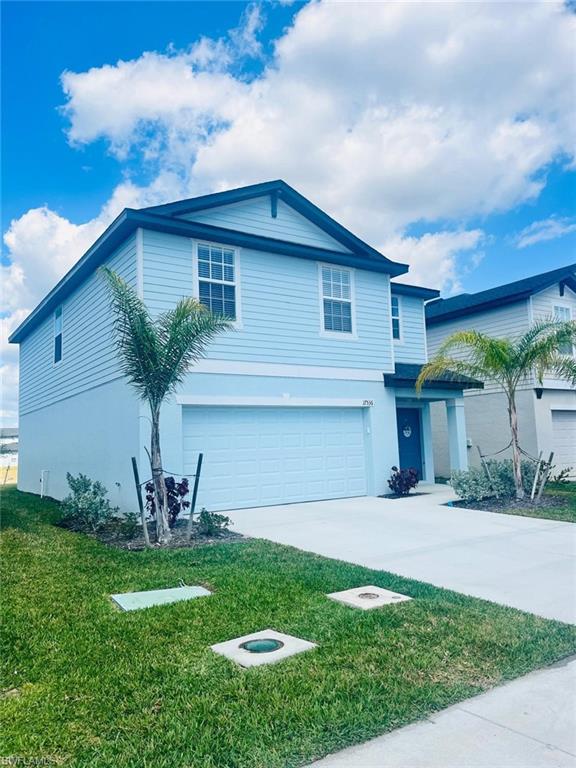 a front view of a house with a garden and yard
