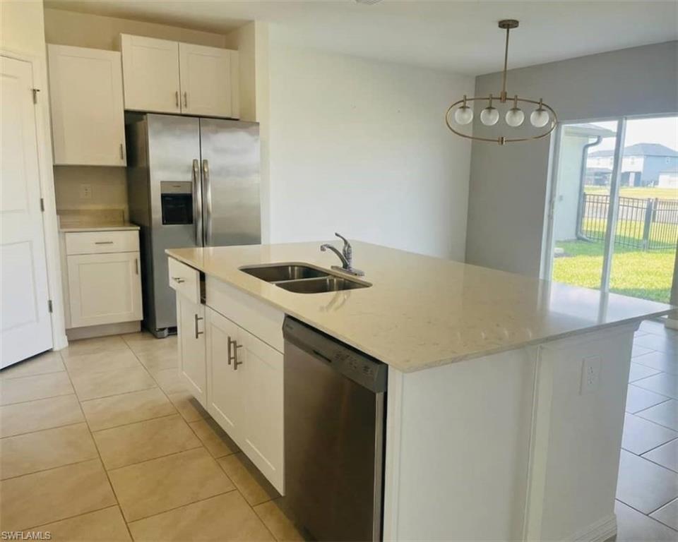 17536 Monte Isola Way North Fort Myers, FL 33917 - Photo 13 of 19 a kitchen with stainless steel appliances granite countertop a sink a refrigerator and a stove