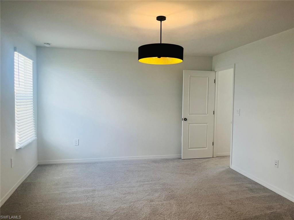 17536 Monte Isola Way North Fort Myers, FL 33917 - Photo 14 of 19 a view of a room with window and chandelier fan