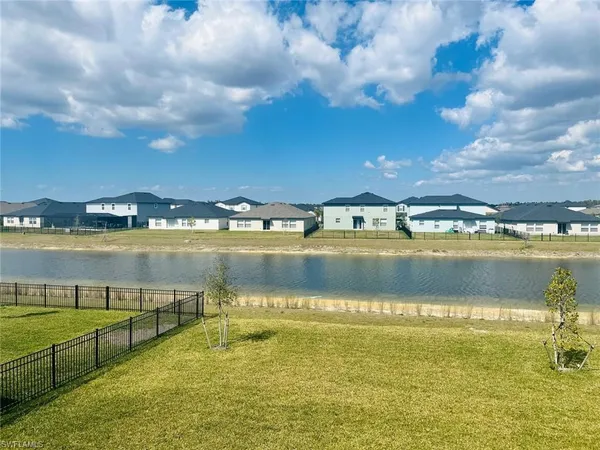 a view of a lake with houses in the background