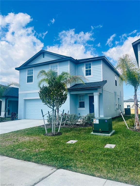 17536 Monte Isola Way North Fort Myers, FL 33917 - Photo 3 of 19 a front view of a house with a garden