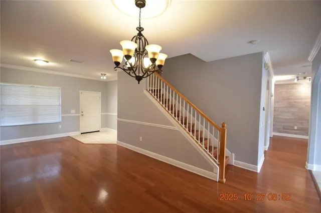 a view of a livingroom with a ceiling fan and window